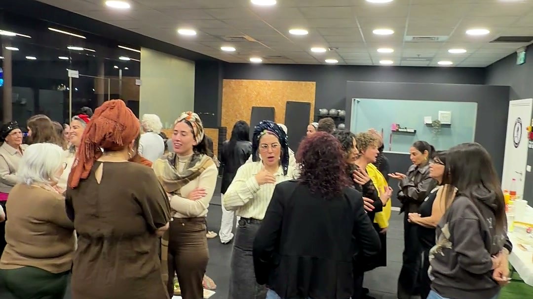 קבוצת מתאמנות עומדת במעגל בסטודיו